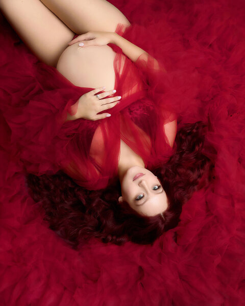 Atlanta maternity photographer, studio portrait lying down in red tulle