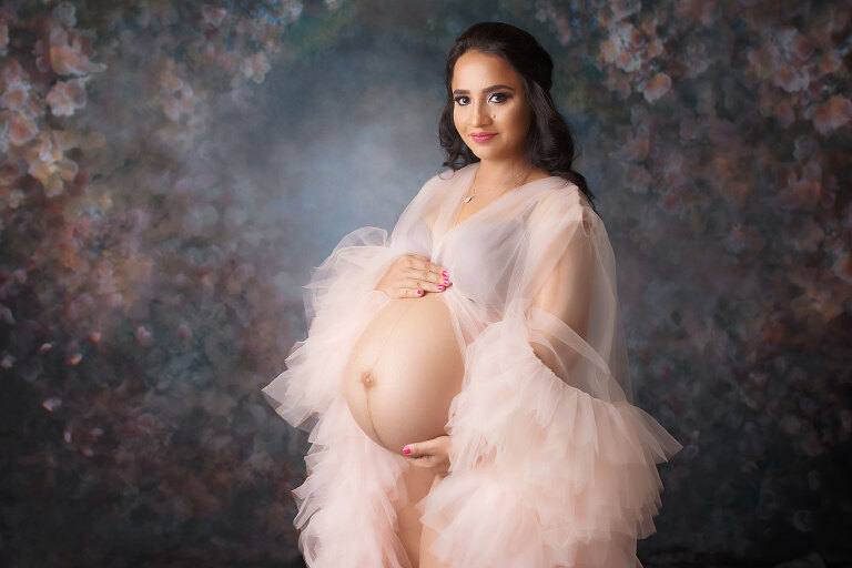 Douglasville maternity photographer, studio portrait on floral backdrop with tulle robe