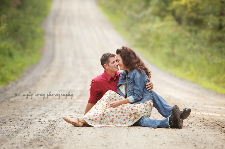 a married couple kissing on a dirt road by a Carrollton couples photographer 