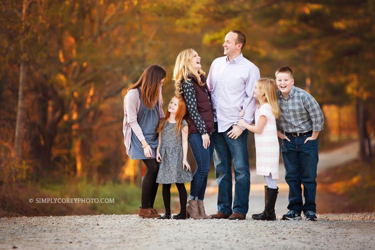 big family of six laughing on a dirt road by Atlanta family photographer
