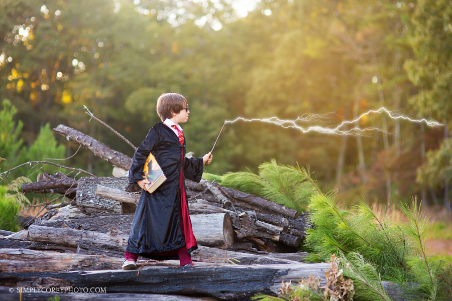 magical Harry Potter themed portraits with wand and books by Atlanta child photographer