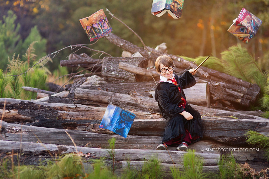 magical Harry Potter themed portraits with wand and books by Atlanta child photographer