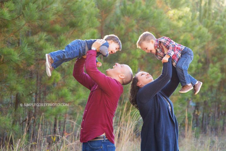 parents playing with their boys outside by Douglasville family photographer