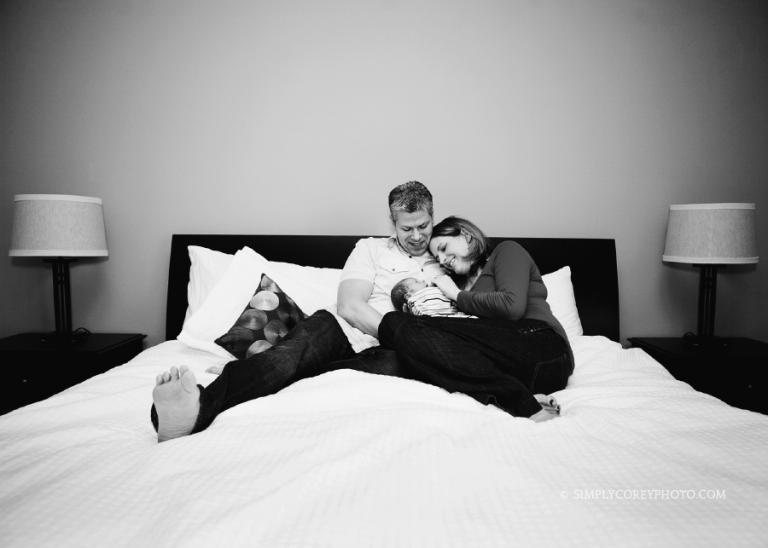 family on a bed in black and white by Atlanta newborn photographer