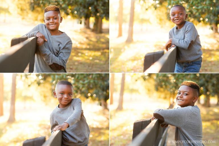 brothers by a fence at Berry College by Atlanta children's photographer