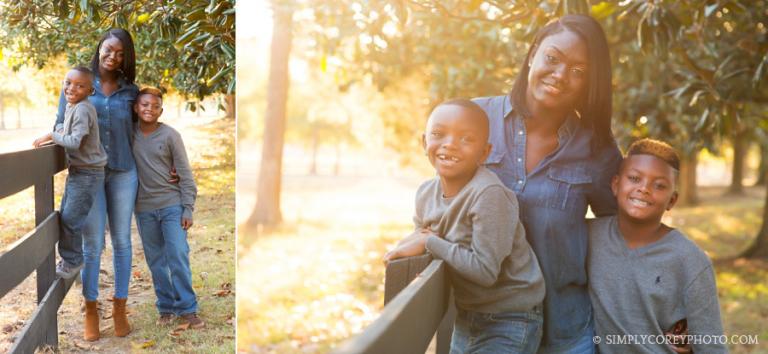 mom and boys by a fence at Berry College by Atlanta family photographer