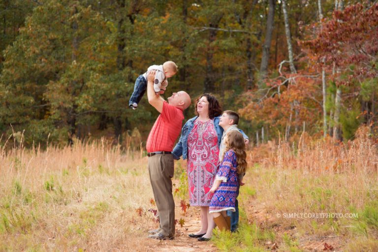 candid portrait in a pasture by Carrollton family photographer