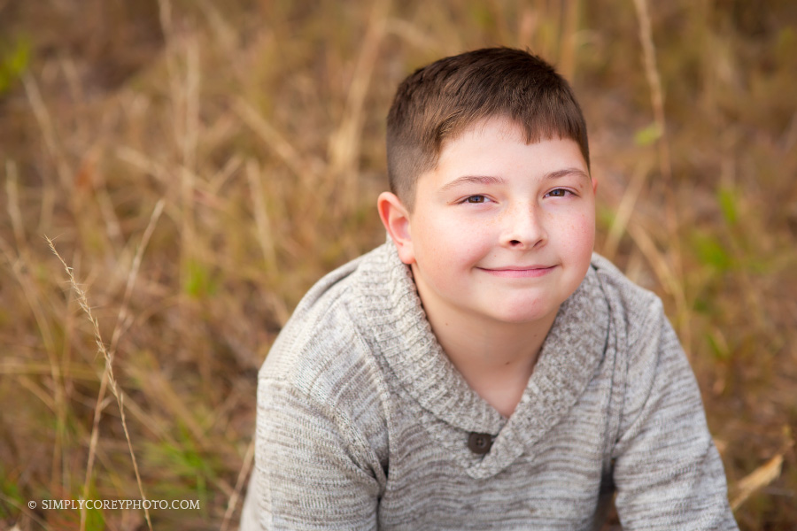 tween boy in a field by Carrollton children's photographer