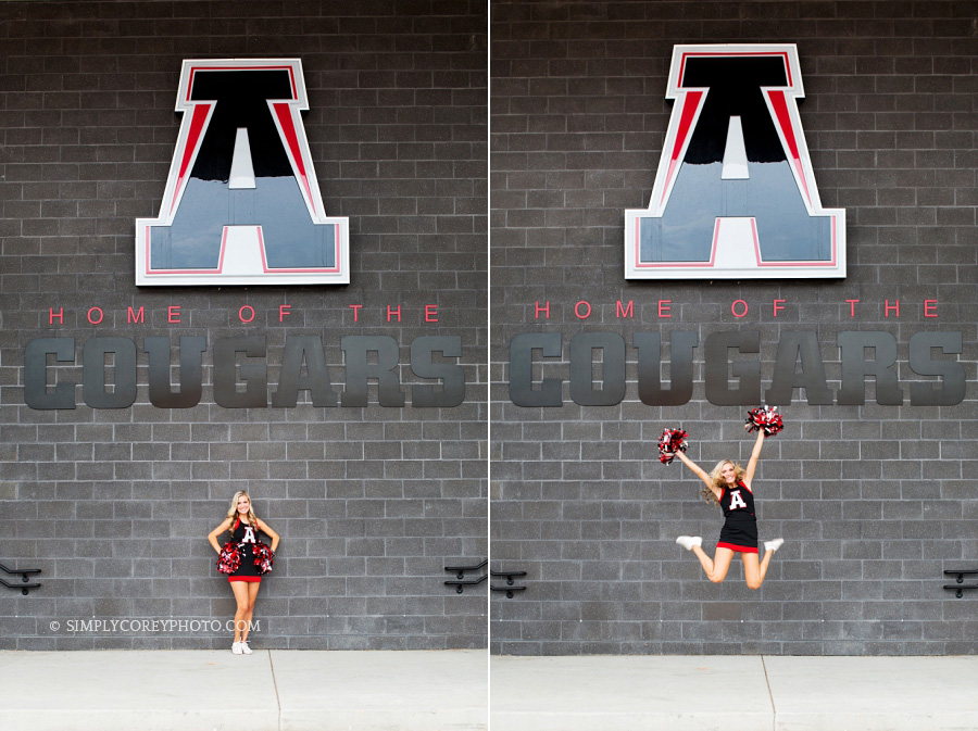 cheerleader jumping in front of Alexander High School sign by Douglasville senior portrait photographer