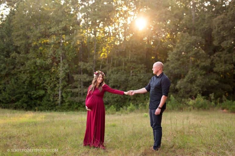 expecting couple outside in sunshine by Atlanta maternity photographer