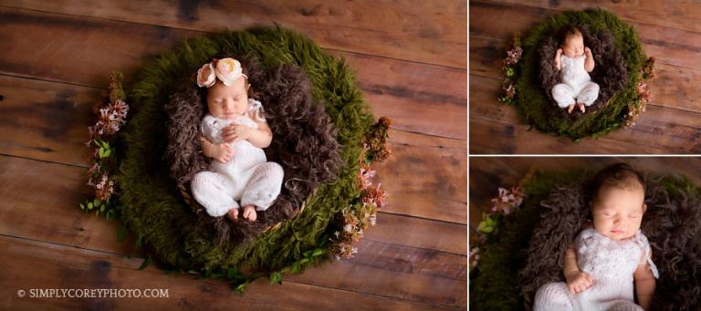 baby girl in a white romper with pink flowers by Newnan newborn photographer