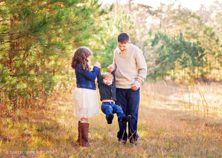 kids playing outside with baby brother by Atlanta family photographer