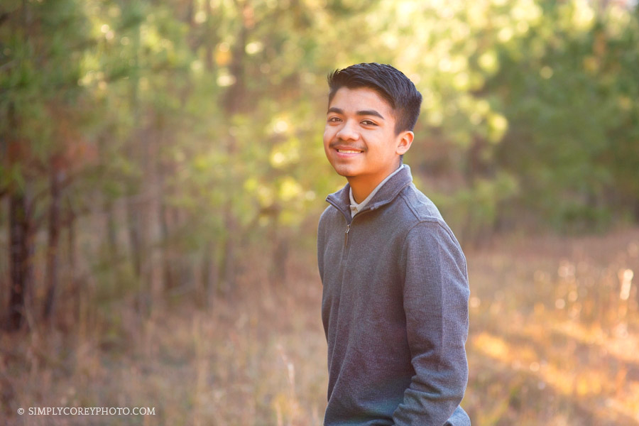 outdoor portrait of a boy in a field by Douglasville teen photographer