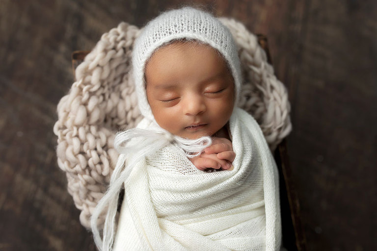 newborn photographer in West Georgia, baby boy in white swaddle and hat