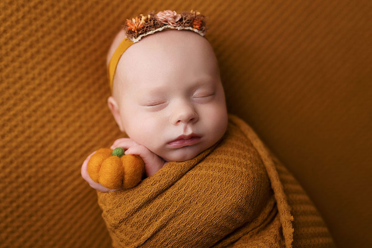Villa Rica newborn photographer, baby girl in mustard studio set with pumpkin