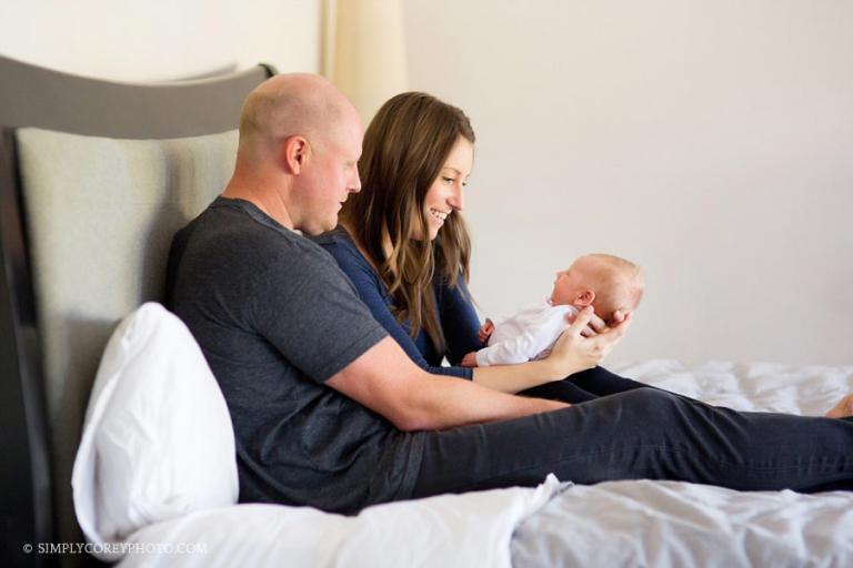 Newnan newborn photographer, family with a new baby on a bed