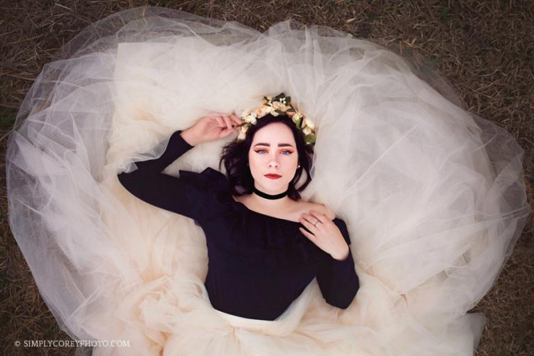 Douglasville senior portrait photographer, girl laying down on a tulle skirt in the grass