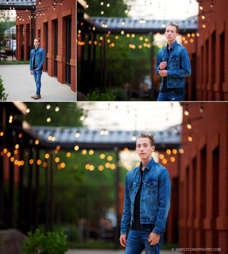 Atlanta senior portraits, teen boy in a jean jacket by string lights in the city