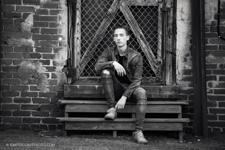 Newnan senior portraits, teen boy downtown by a brick wall