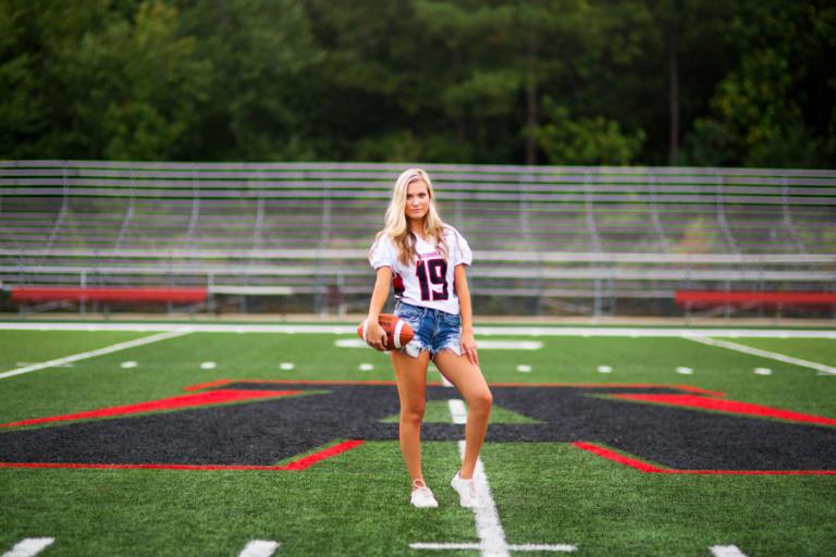 Douglasville senior portraits of a cheerleader on the Alexander High football field