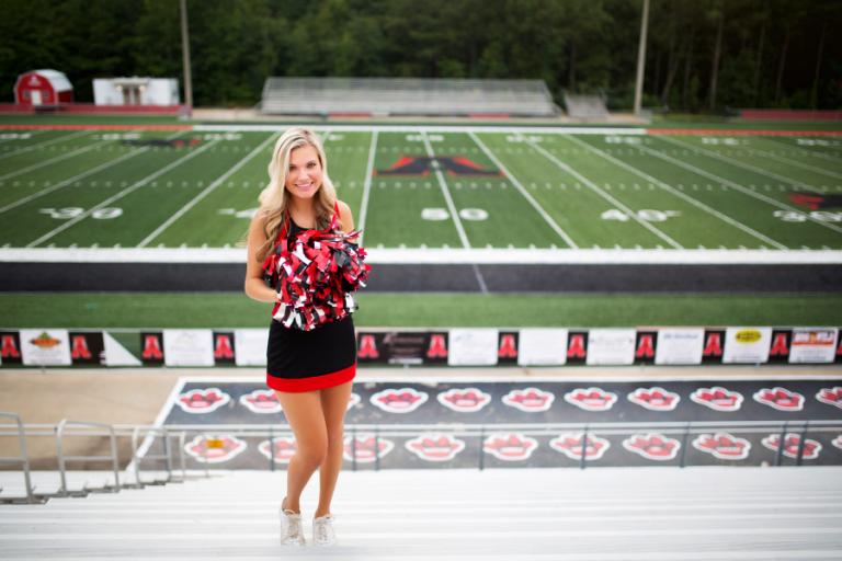 Douglasville senior portrait photographer, cheerleader at Alexander High football field