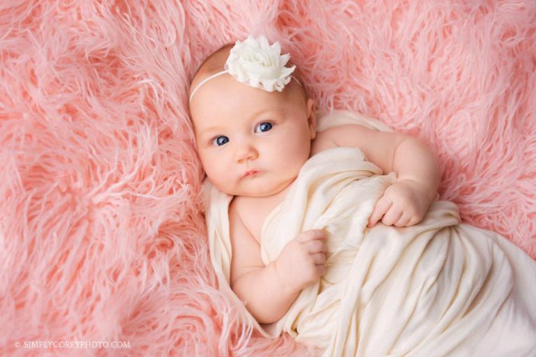 Villa Rica baby photographer; baby girl on pink fur in studio