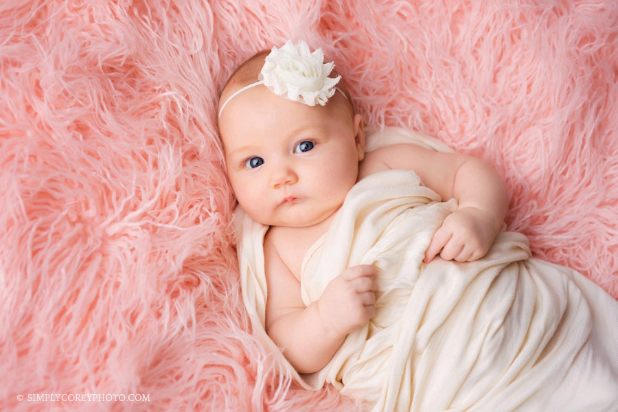 Villa Rica baby photographer; baby girl on pink fur in studio