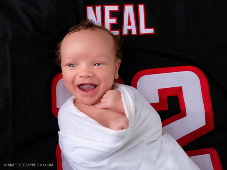 Georgia newborn photographer, baby smiling on Atlanta Falcons jersey