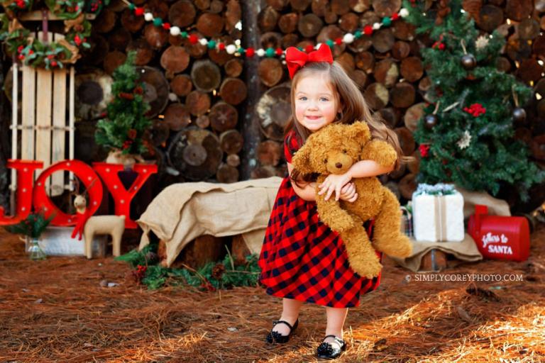 Atlanta Christmas mini sessions, girl hugging teddy bear outside