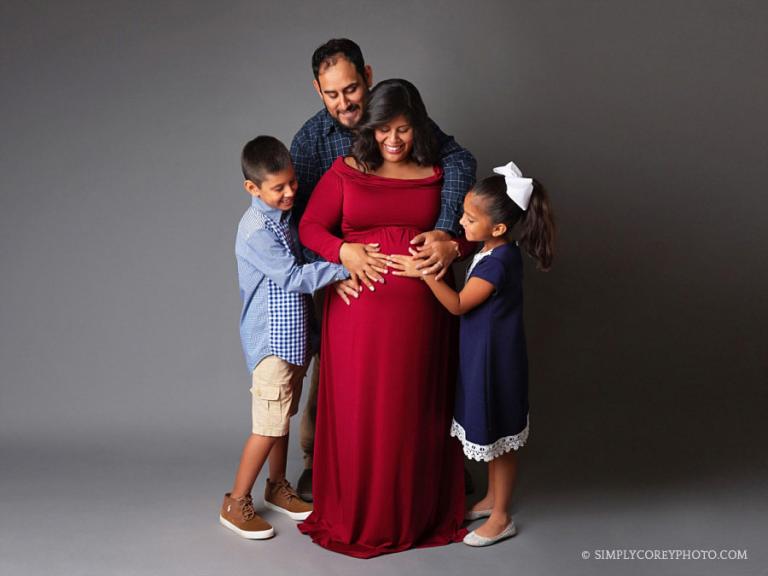 Douglasville maternity photographer, family with hands on baby bump
