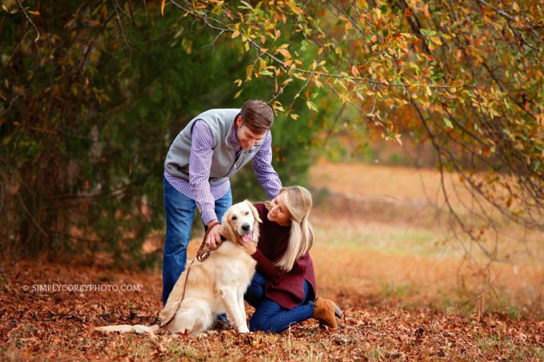 Newnan family photographer, couple outside with pet Golden Retriever