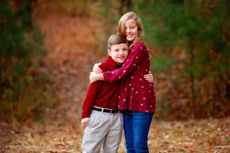 Newnan family photographer, fall portrait of siblings hugging