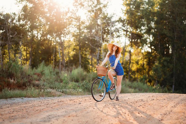 Atlanta senior portrait photographer, teen in floppy hat on a vintage bicycle