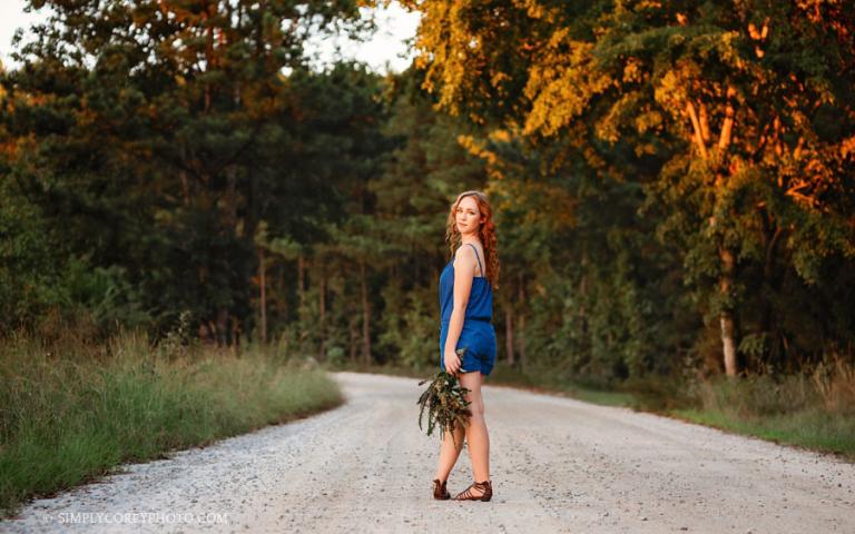 Bremen senior portrait photographer, teen with flowers on a country road