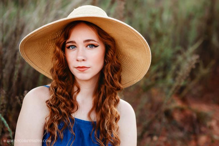 Villa Rica senior photographer, teen with red curly hair in a floppy hat