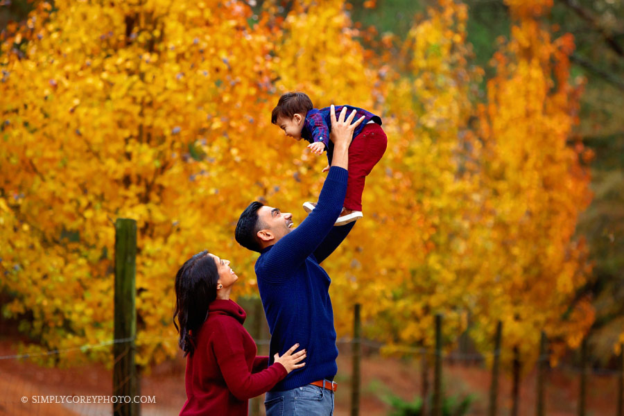 family photographer, Newnan, candid fall portrait with yellow leaves