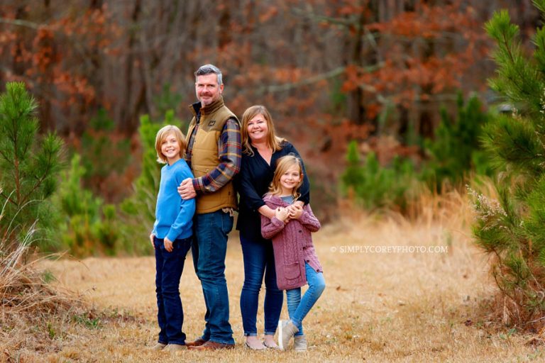 Atlanta family photographer, fall portrait of family hugging outside in a field