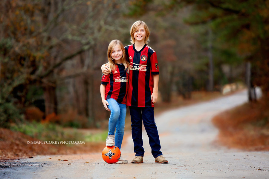 family photographer near Atlanta, children in soccer uniforms outside