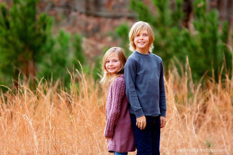 Newnan family photographer, children in a field with tall grass