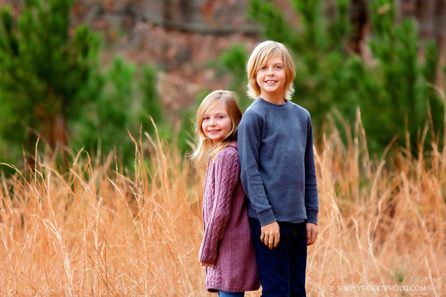 Newnan family photographer, children in a field with tall grass