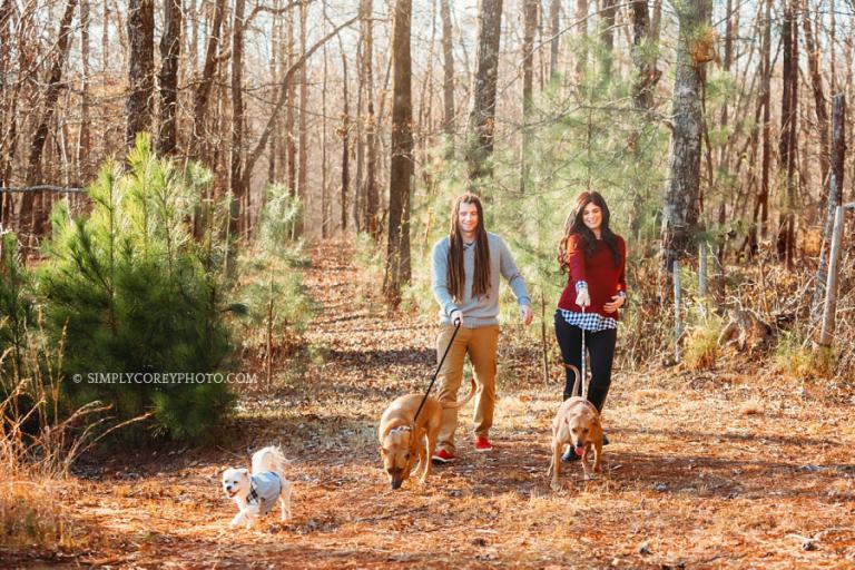 Douglasville maternity photographer, couple walking three dogs