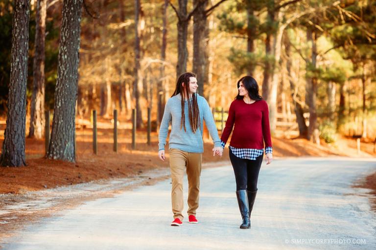 maternity photographer near Douglasville, couple walking on country road