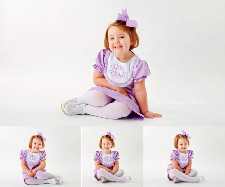 studio photography near Douglasville, child on white backdrop in monogrammed dress