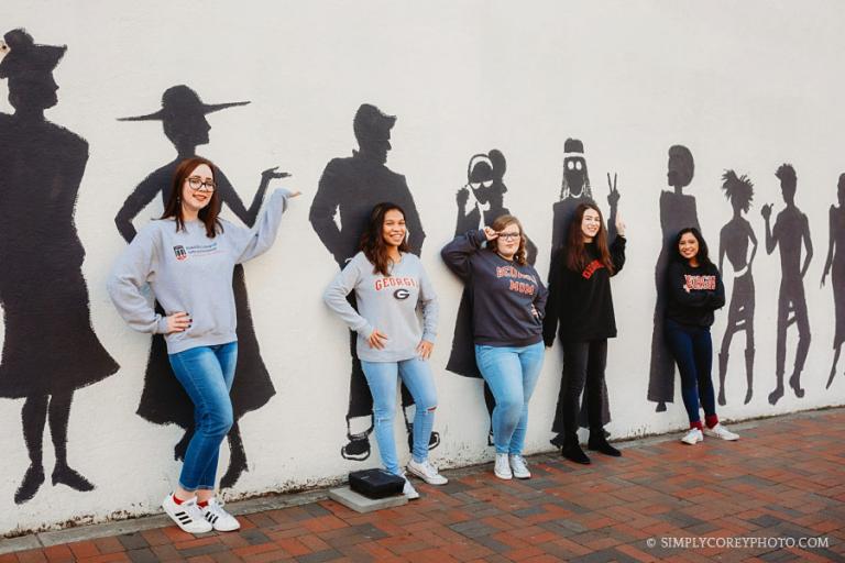 West Georgia senior photographer, college friends by a mural in Marietta Square