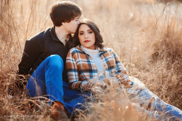 Newnan engagement photographer, couple sitting in tall golden grass