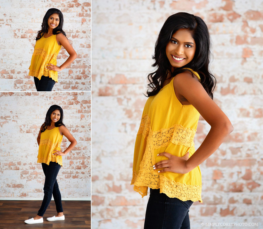 senior portrait photographer near Newnan, teen on white brick wall in studio