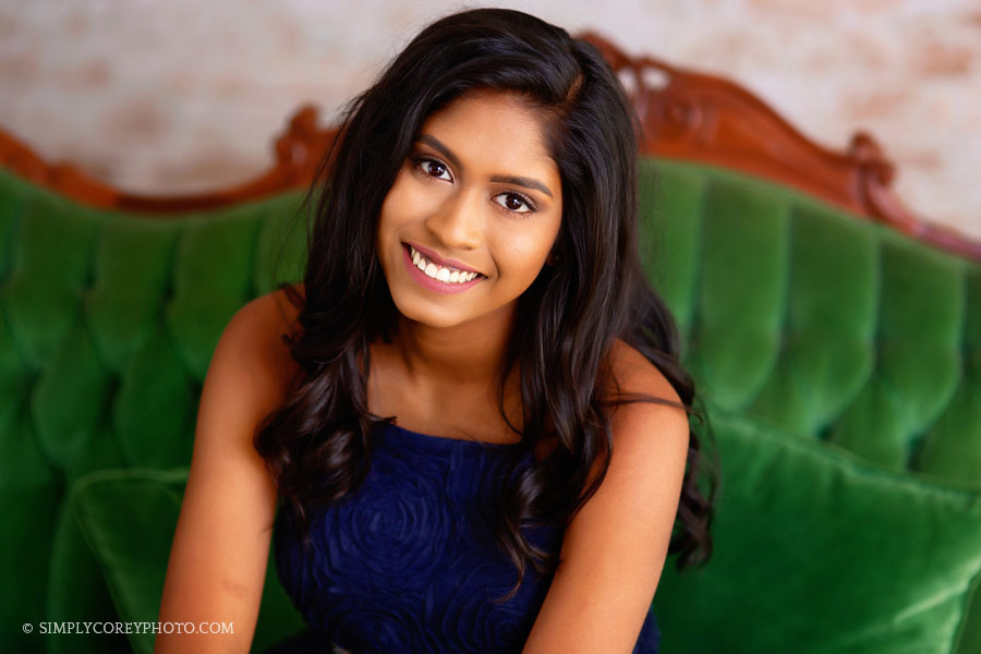 senior portrait photographer near Villa Rica, teen on green couch