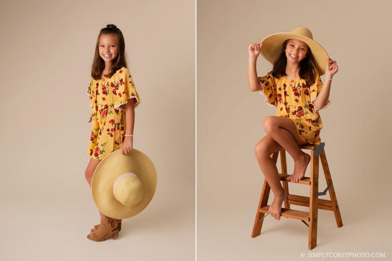 children's photographer near Douglasville, child in studio with a floppy hat