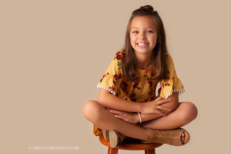 Douglasville children's photographer, child sitting on a stool in studio