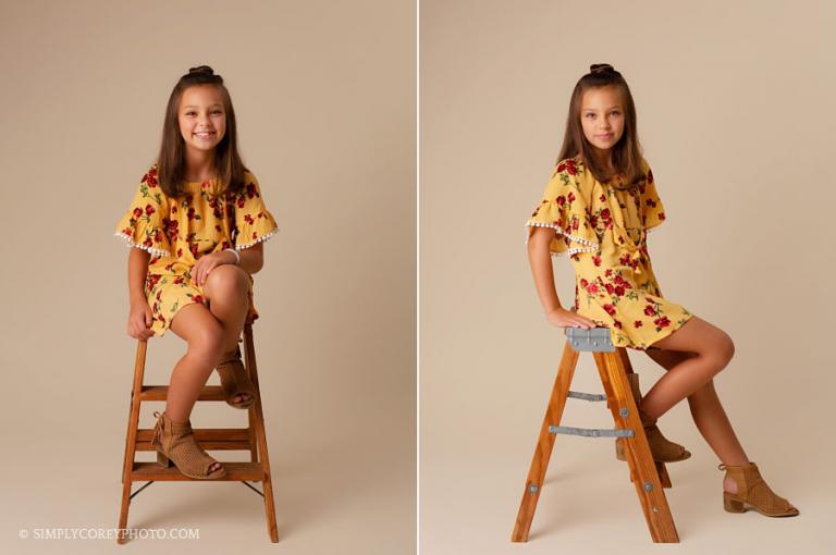 Newnan children's photographer, child on bone studio backdrop and ladder